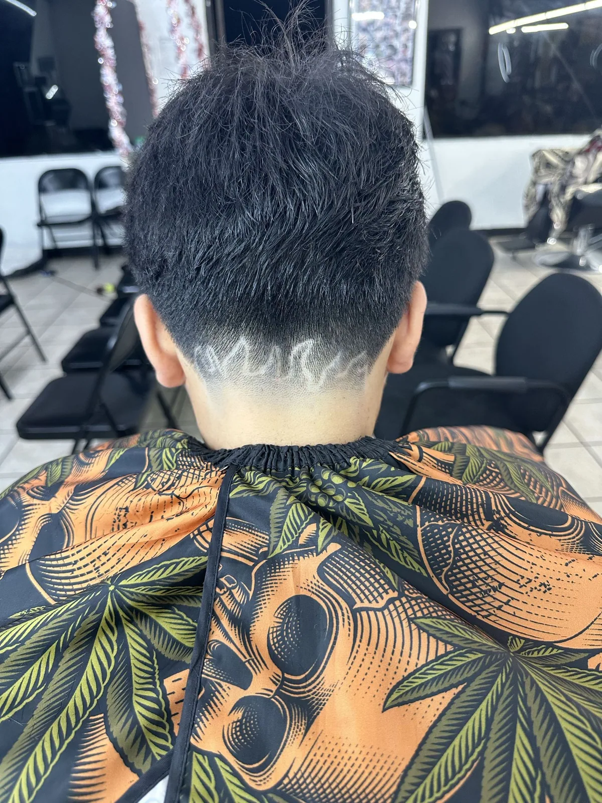 Custom line design carved into the back of a tapered haircut